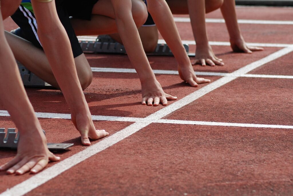 Hands on the ground, lined up for a race