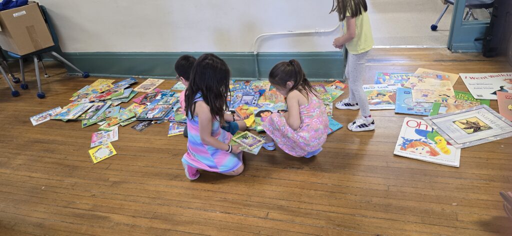 Kindergarten students picking books